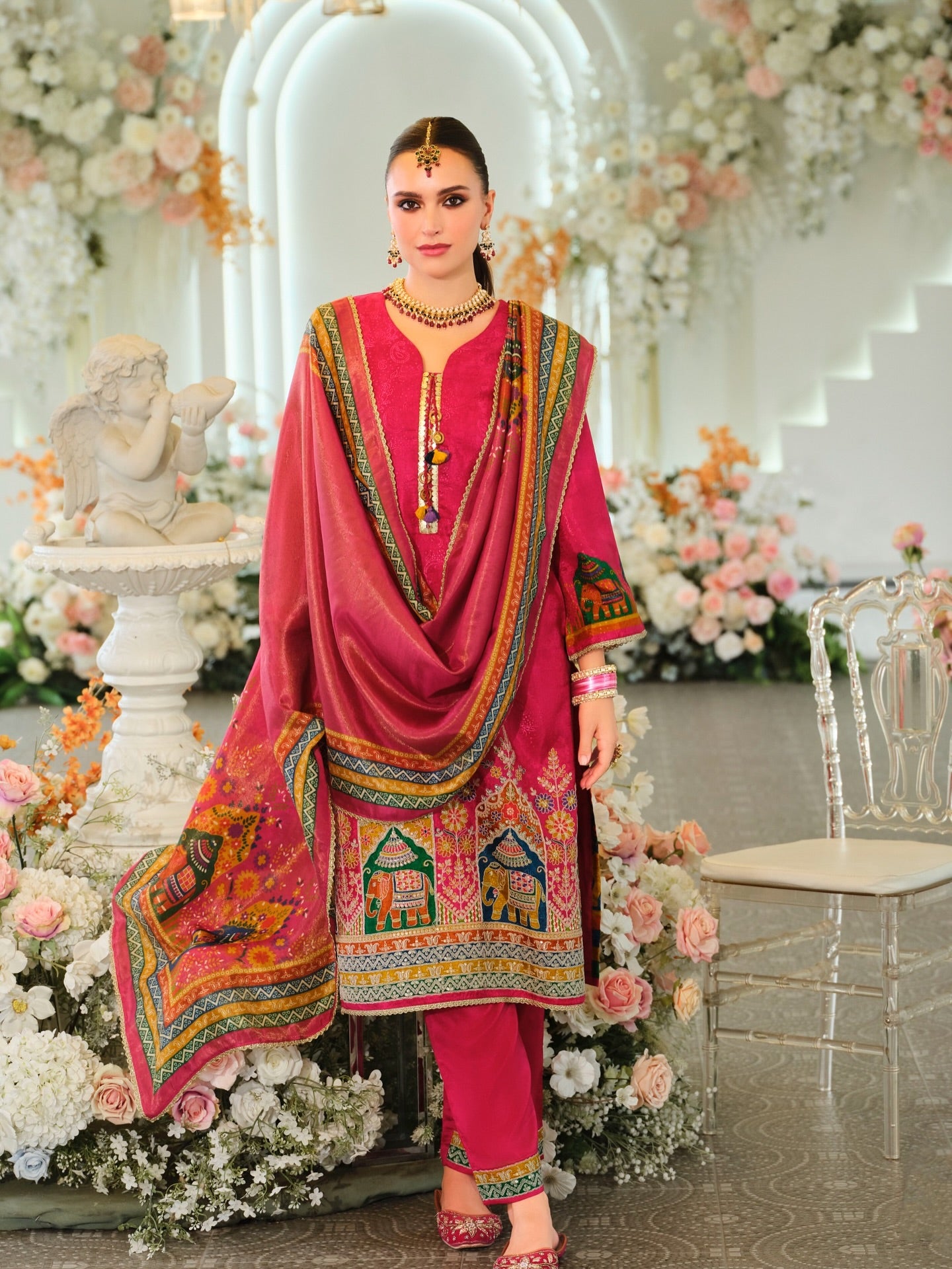 Rich pink embroidered ethnic suit with regal motifs and elegant styling.Select 89 more words to run Humanizer.